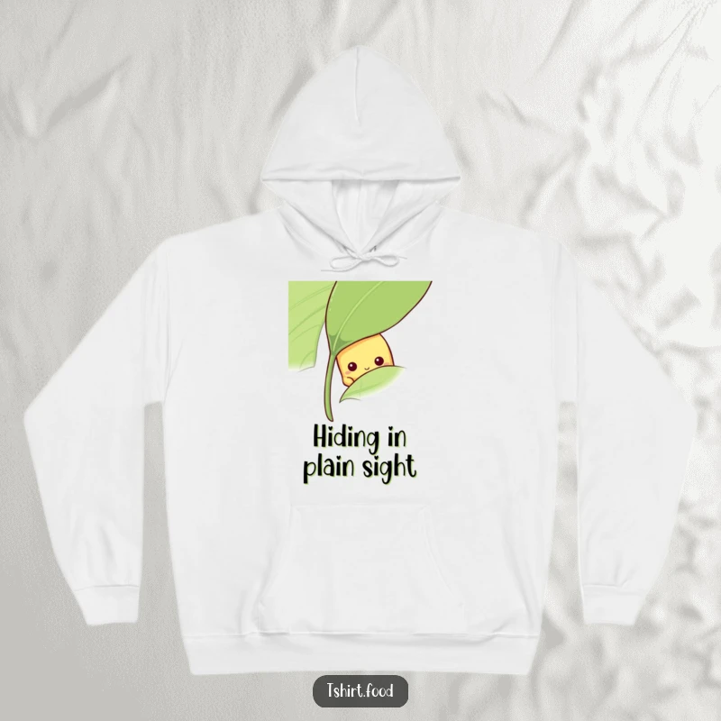 Funny shy banana hoodie with a fruit peeking from behind a leaf, a comfy funny gift.