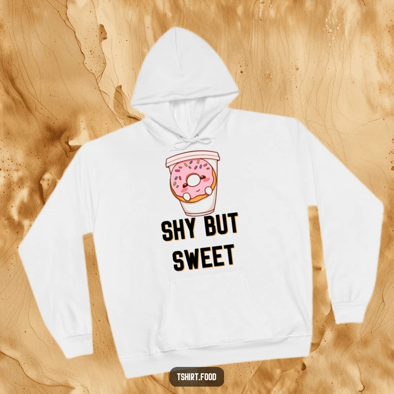 Funny shy donut hoodie showing a blushing donut with sprinkles hiding behind a coffee cup, cozy and irresistibly cute.