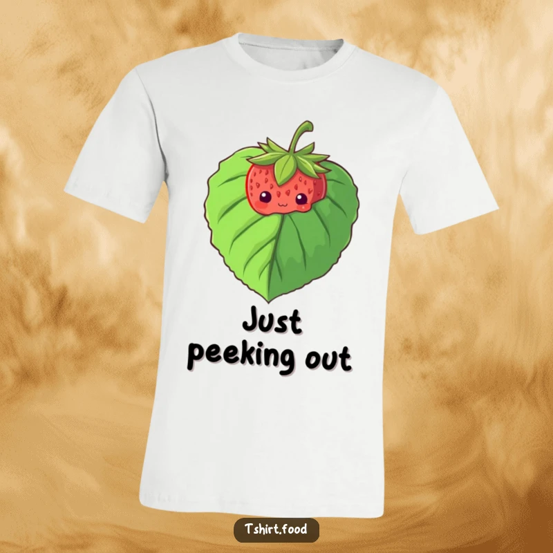 Funny t-shirt graphic of a shy strawberry cautiously peeking from behind a large leaf, conveying sweetness and modesty.